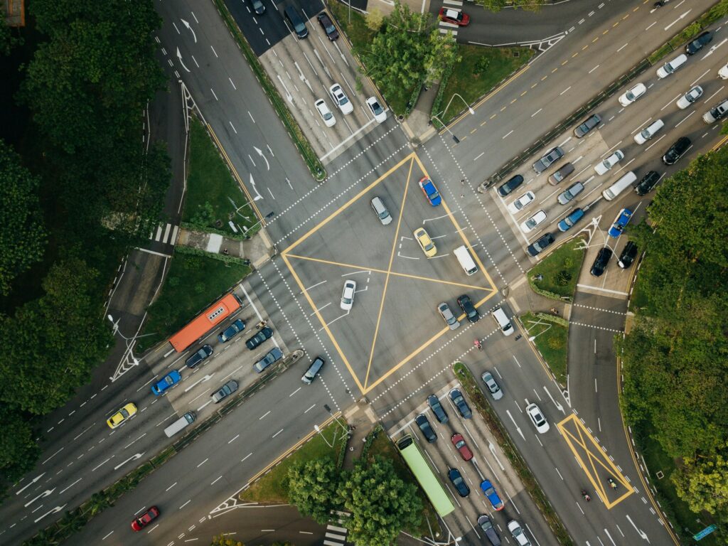 Aerial view of a busy intersection with multiple lanes and traffic signals, representing the risk of car accidents in high-traffic areas.